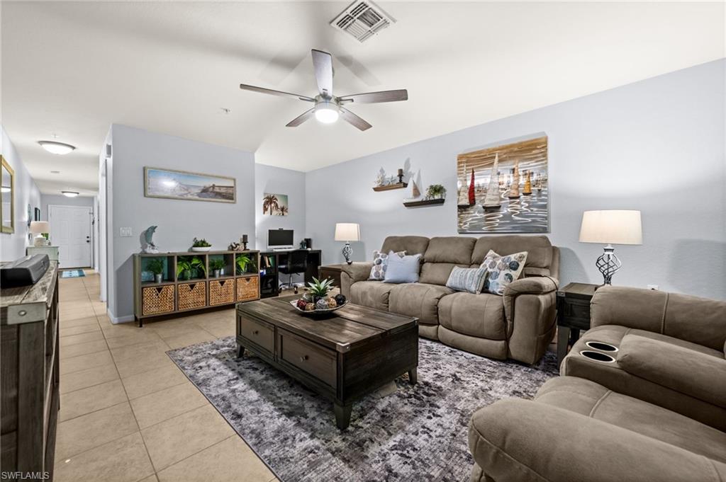 Open-concept living space featuring a ceiling fan, recessed lighting, and tile flooring