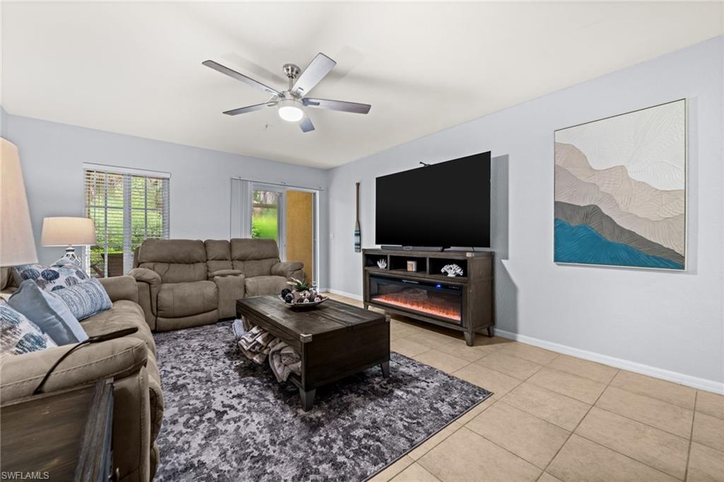 Living area featuring light-toned walls and tile flooring
