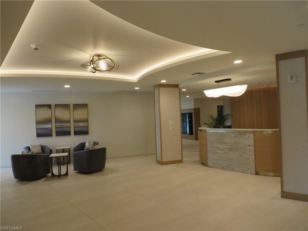 Lobby reception area featuring recessed lighting and a tray ceiling