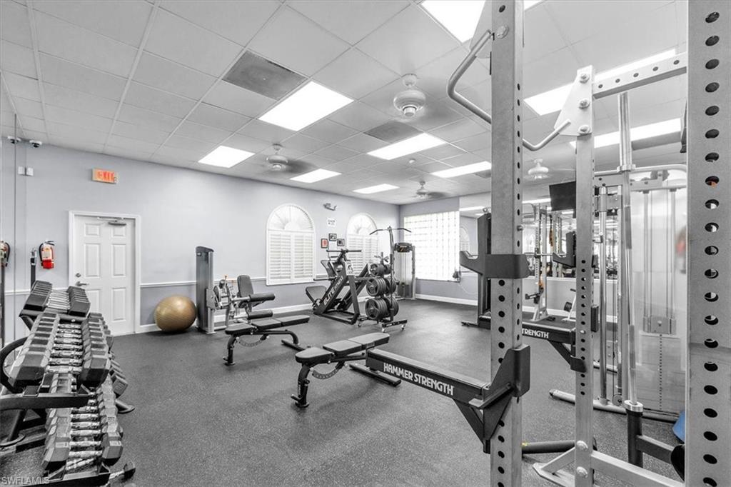 Dedicated fitness center featuring rubber flooring and extensive workout equipment