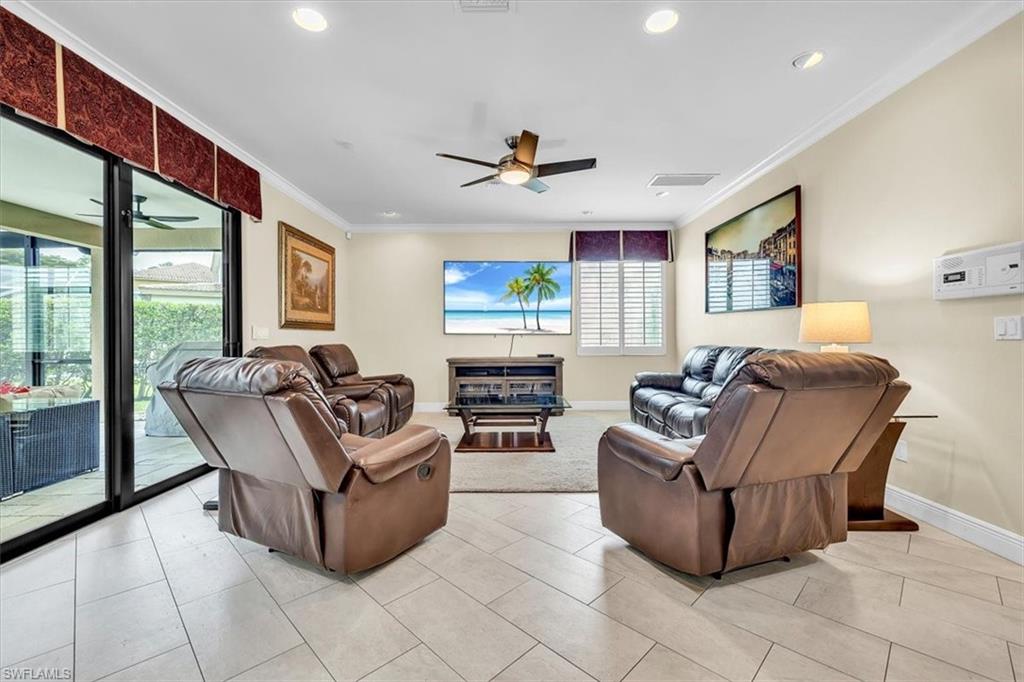 Spacious living area featuring tile flooring, recessed ceiling lighting, and a ceiling fan