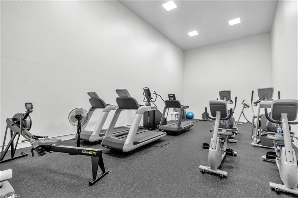 Dedicated fitness room featuring a rubberized floor and recessed ceiling lighting