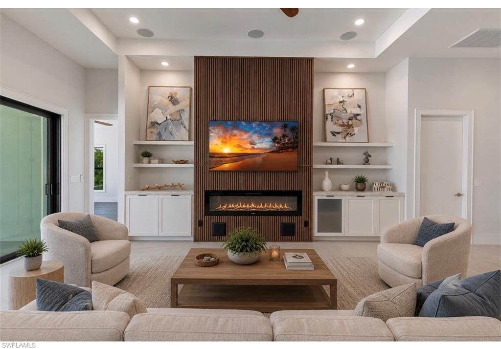 LVirtual Staged. Living space featuring a wood-slat accent wall, built-in electric fireplace, and recessed lighting