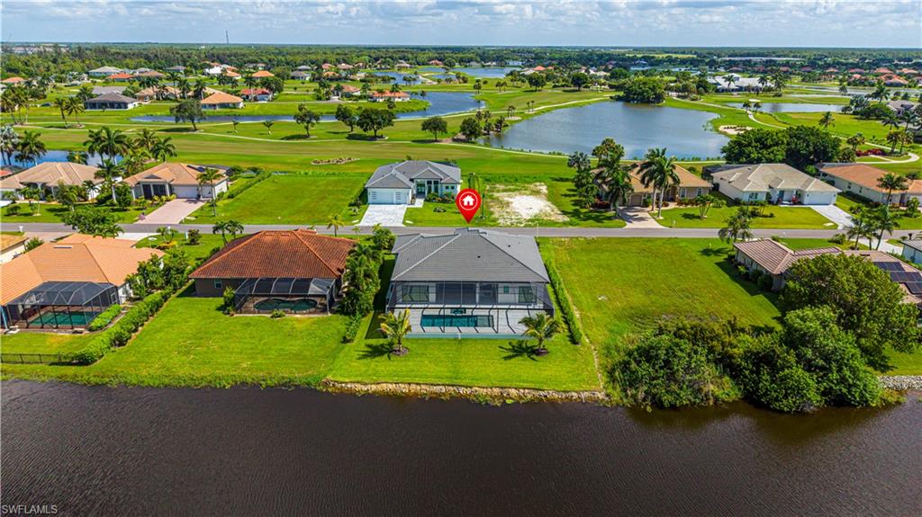 Waterfront property with a screened-in pool and covered patio