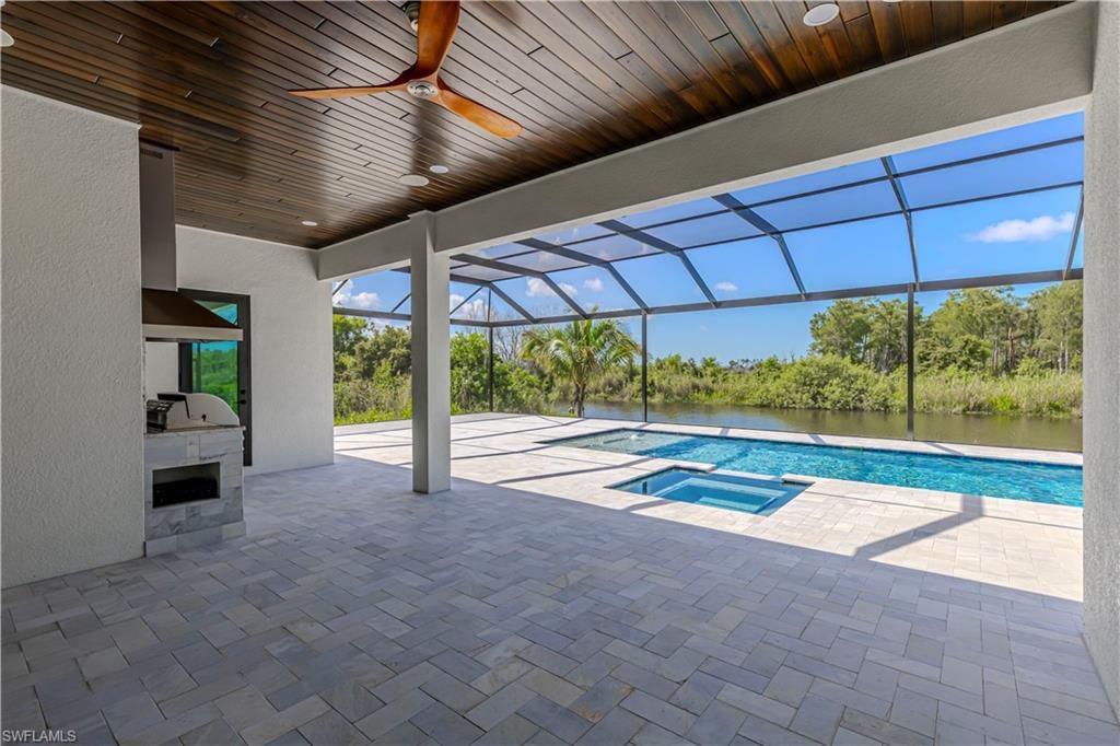 Screened lanai featuring a swimming pool, integrated spa, and waterway frontage