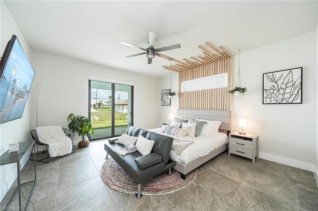 Spacious room featuring large format tile flooring, a vaulted ceiling, and sliding glass doors