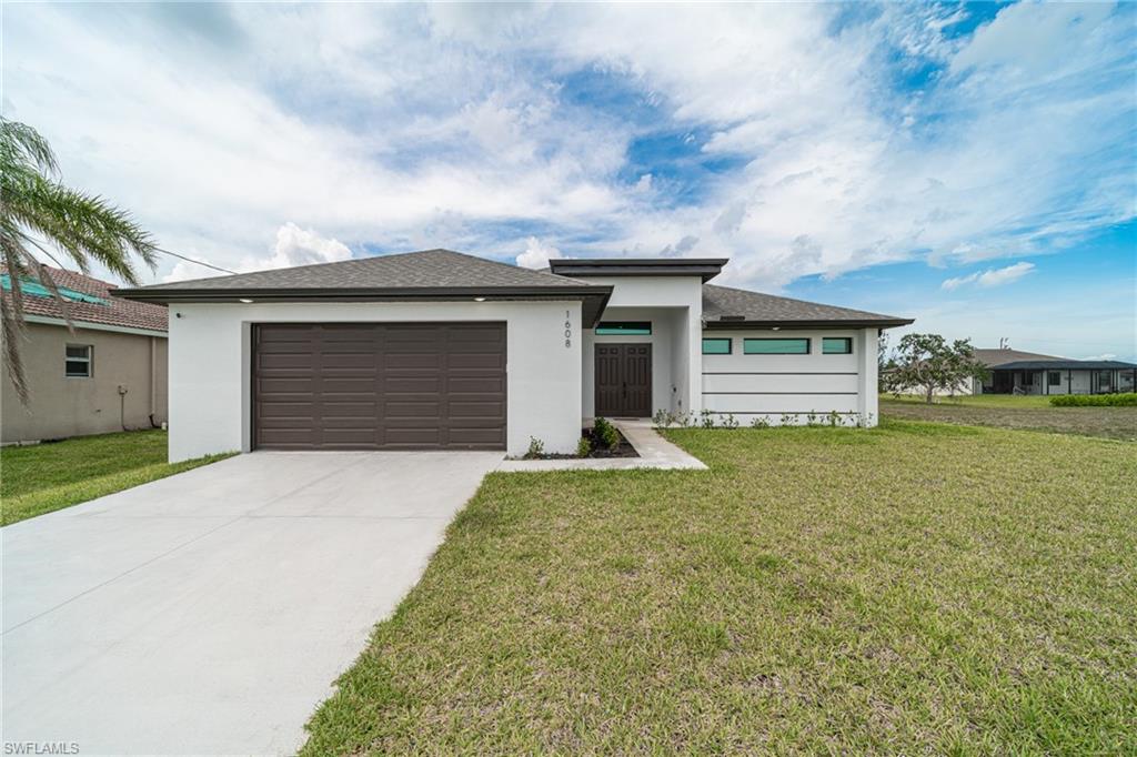 Contemporary white stucco exterior with a dark brown garage door