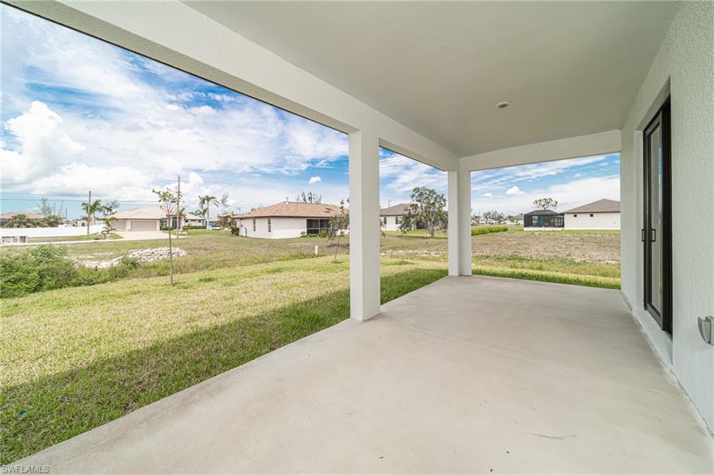 Expansive covered patio featuring a concrete slab, recessed lighting, and a stucco exterior
