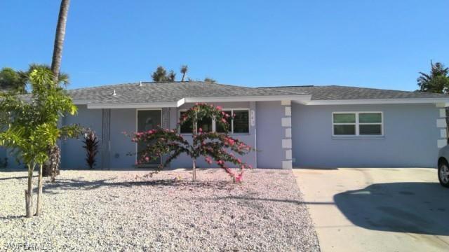 Ranch-style exterior featuring a light blue stucco finish with decorative white quoins
