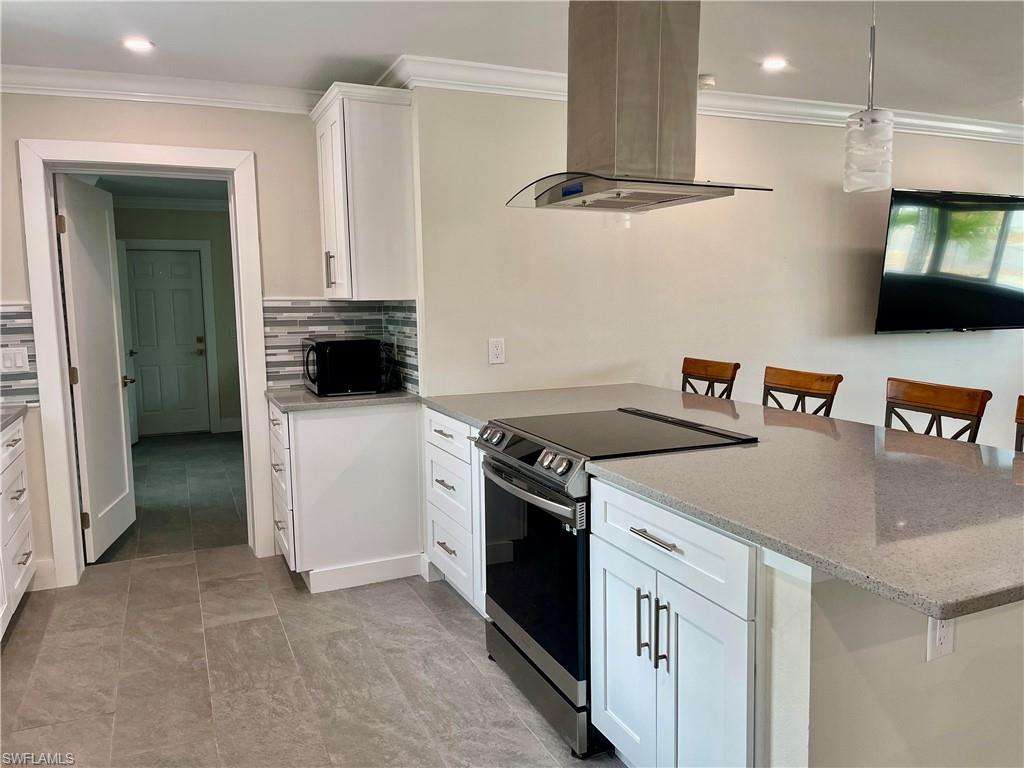 Modern kitchen featuring white shaker cabinetry with brushed nickel hardware