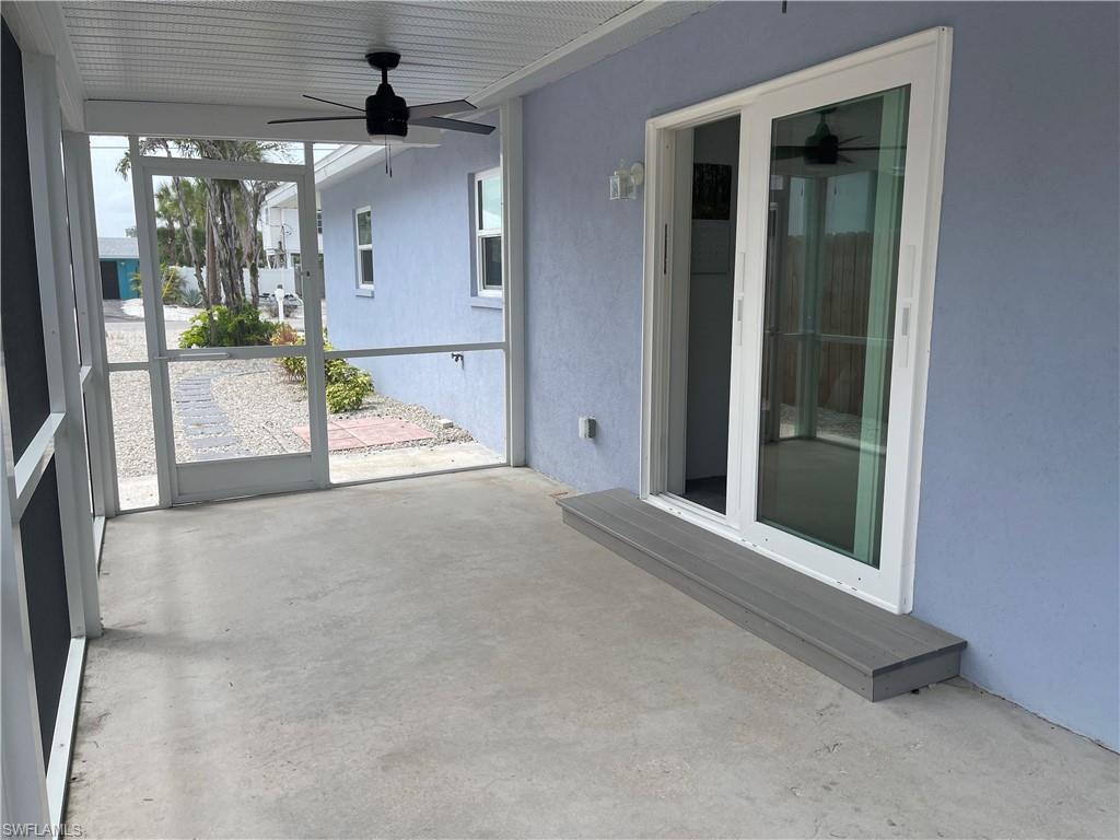Screened patio featuring a solid concrete floor and white aluminum framing