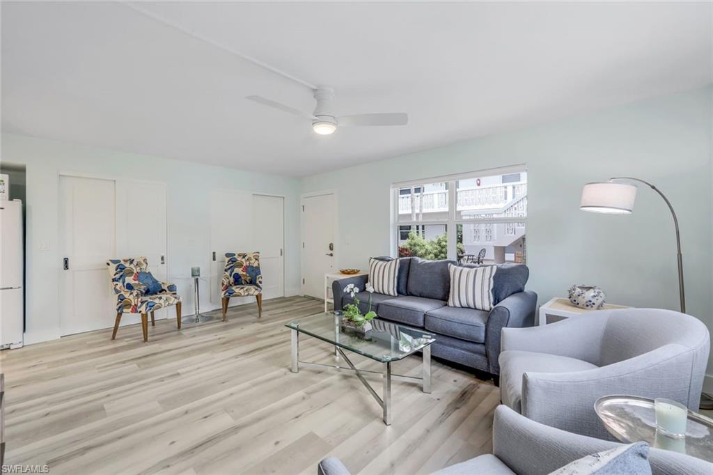 Living room with light floors and ceiling fan