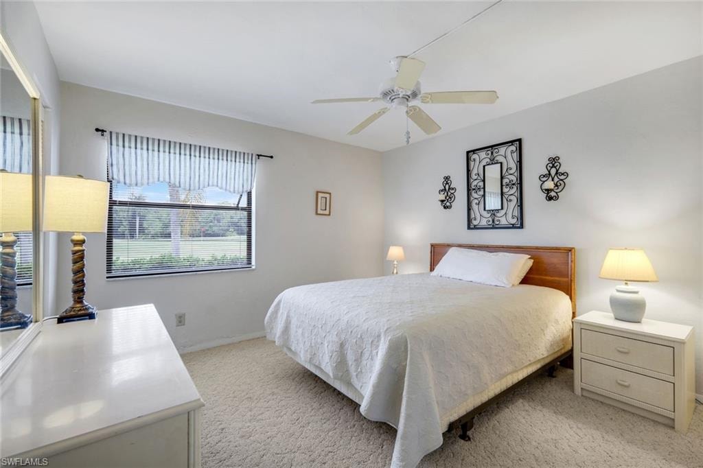 Guest bedroom features golf course and lake views.