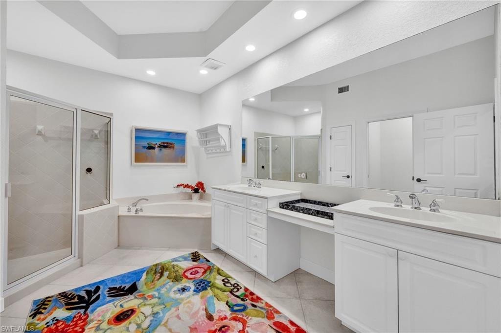 Ensuite primary bathroom features dual vanities, a soaking tub and a walk-in shower.