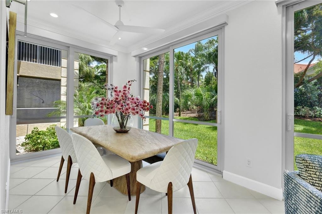 Formal dining overlooks lush landscaping with floor to ceiling windows.
