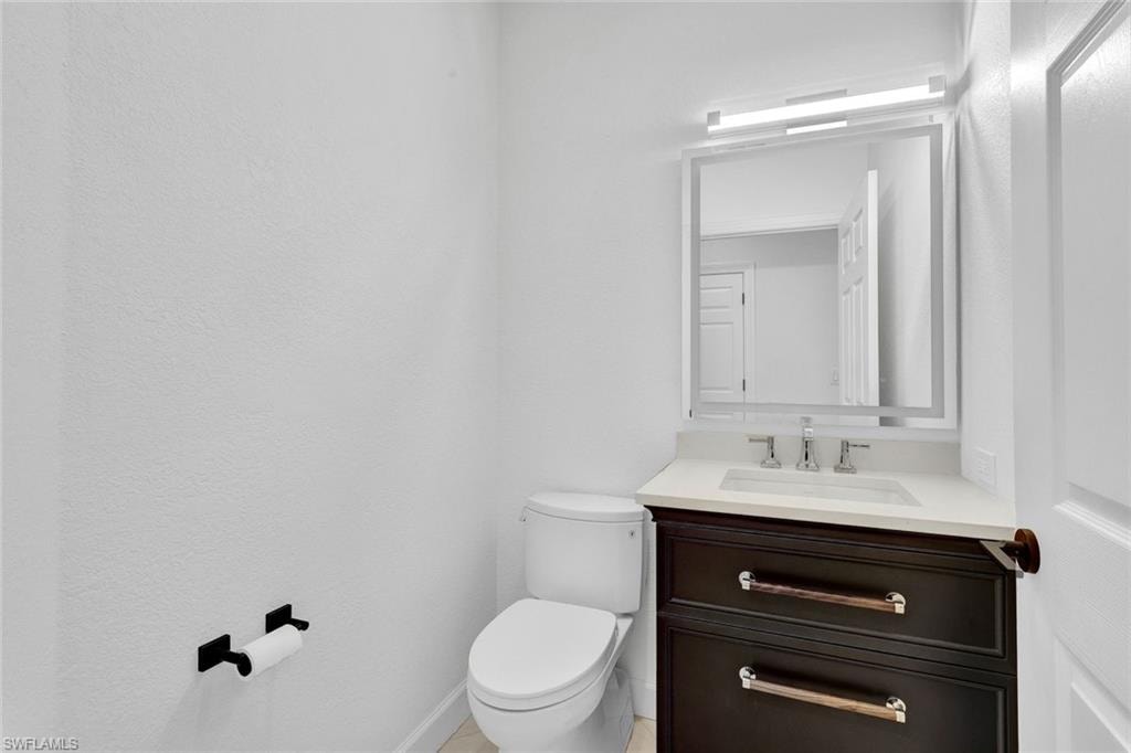 Powder room features a brand new vanity.