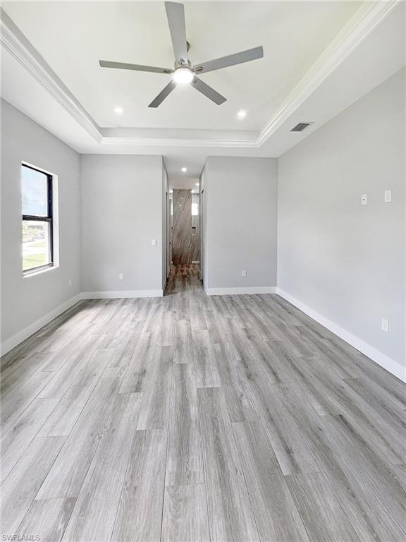 Spare room with a ceiling fan, light wood-style flooring, and recessed lighting