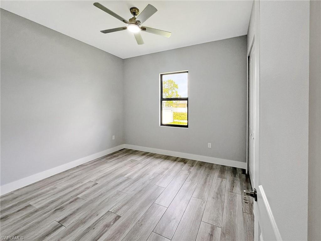 Unfurnished bedroom featuring a ceiling fan and light wood finished floors