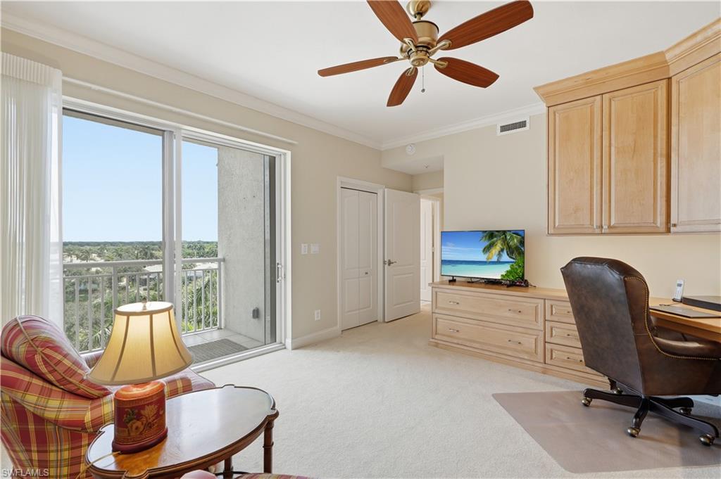 Versatile den or home office with a wall of windows and access to the outdoor living area.