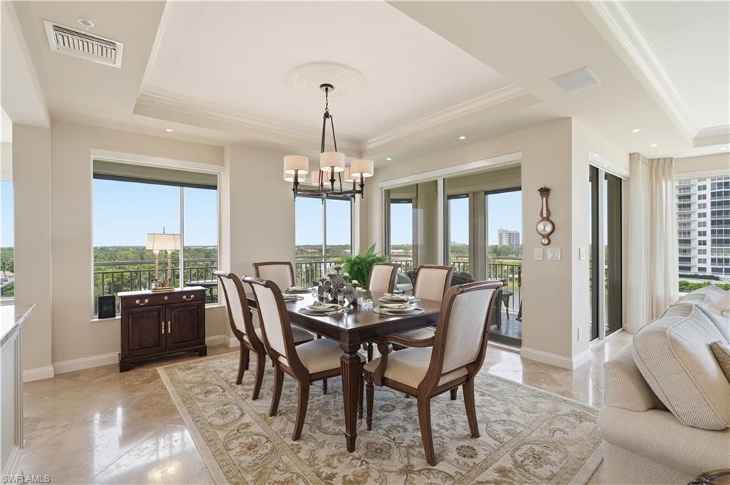 A bright, comfortable dining space surrounded by windows and lovely views.