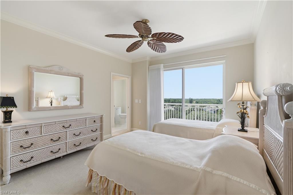 Bright guest bedroom with a large window and plenty of natural light.