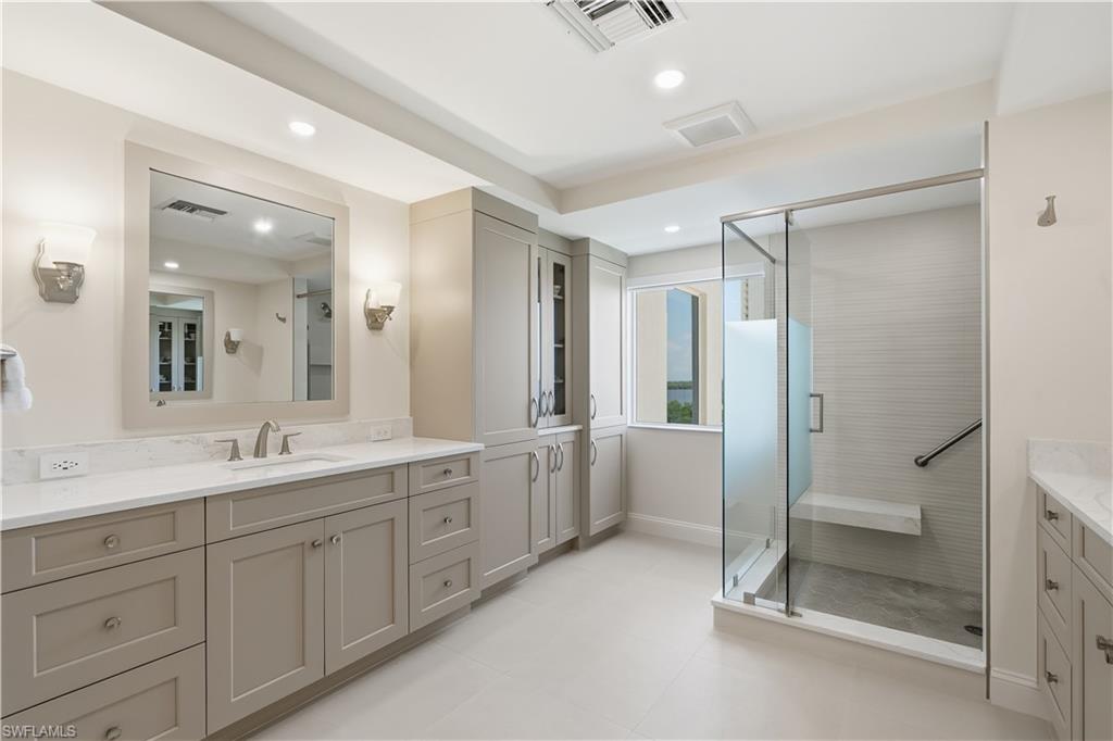 Large ensuite primary bath with double vanity, lots of storage and a walk-in shower.