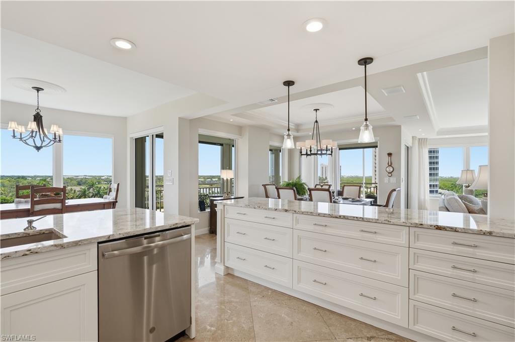 Bright, open kitchen with expansive countertops, abundant cabinetry, and scenic views.