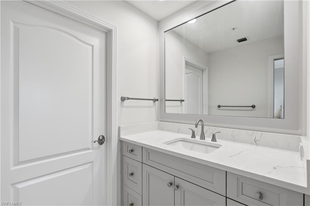Updated guest bath with a large vanity and good storage.