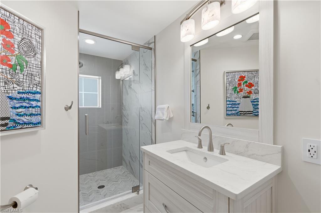 Fresh, beautifully updated guest bath with a large vanity, glass-enclosed shower, and clean modern finishes.