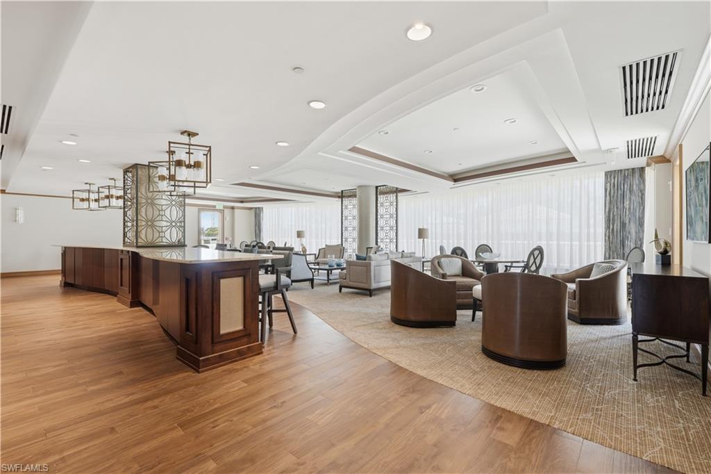Resident social room with several conversation areas and plenty of space to gather.