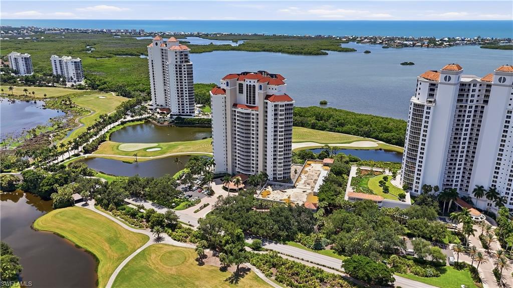 Aerial view of the community surrounded by golf, lakes and lush landscaping.