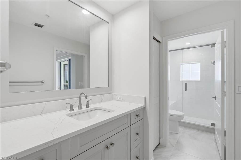 Guest bath with a tub/shower combination and plenty of counter space.