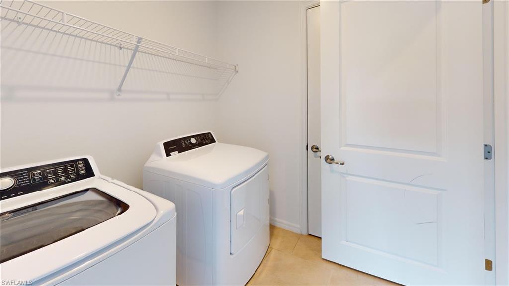 Dedicated laundry area with light-colored tile flooring