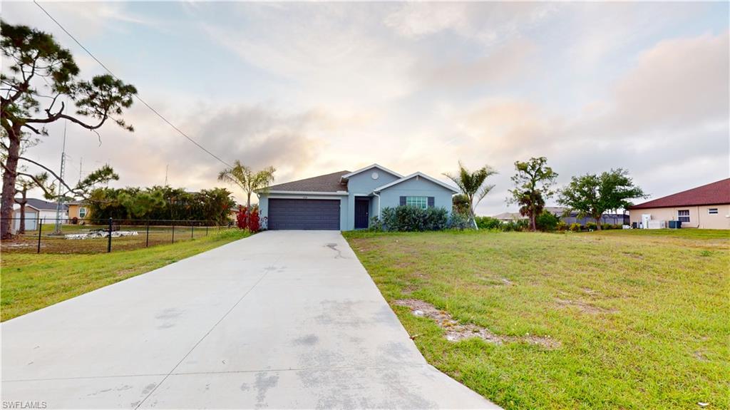 Single-story residence featuring a two-car garage and a concrete driveway