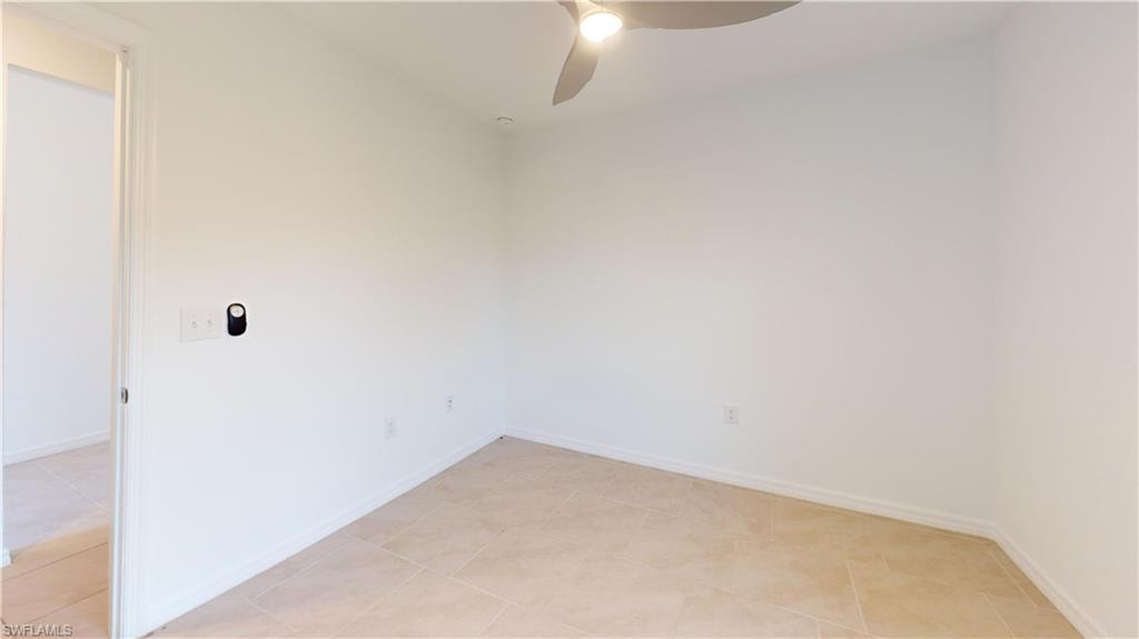 Room featuring tiled flooring, white walls, and a ceiling fan