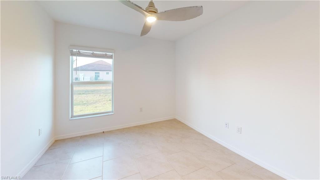 Room featuring light-toned tile flooring, white walls, and a window with blinds