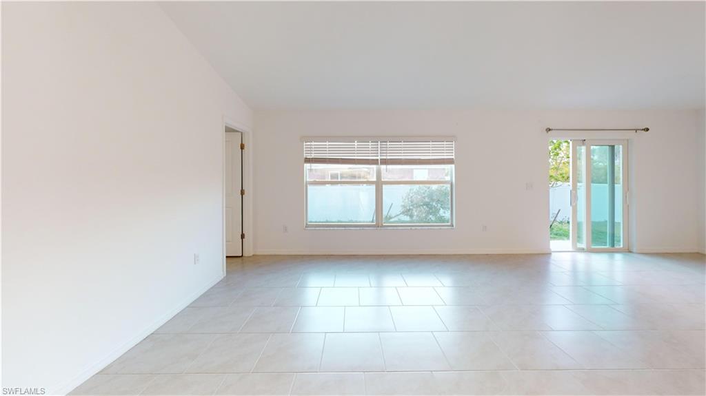 Spacious interior featuring light-colored tile flooring throughout