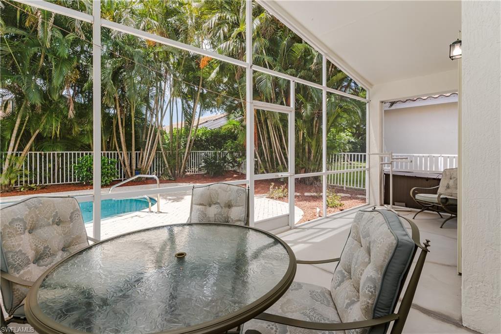 Screened-in patio with concrete flooring, integrated lighting, and a white railing