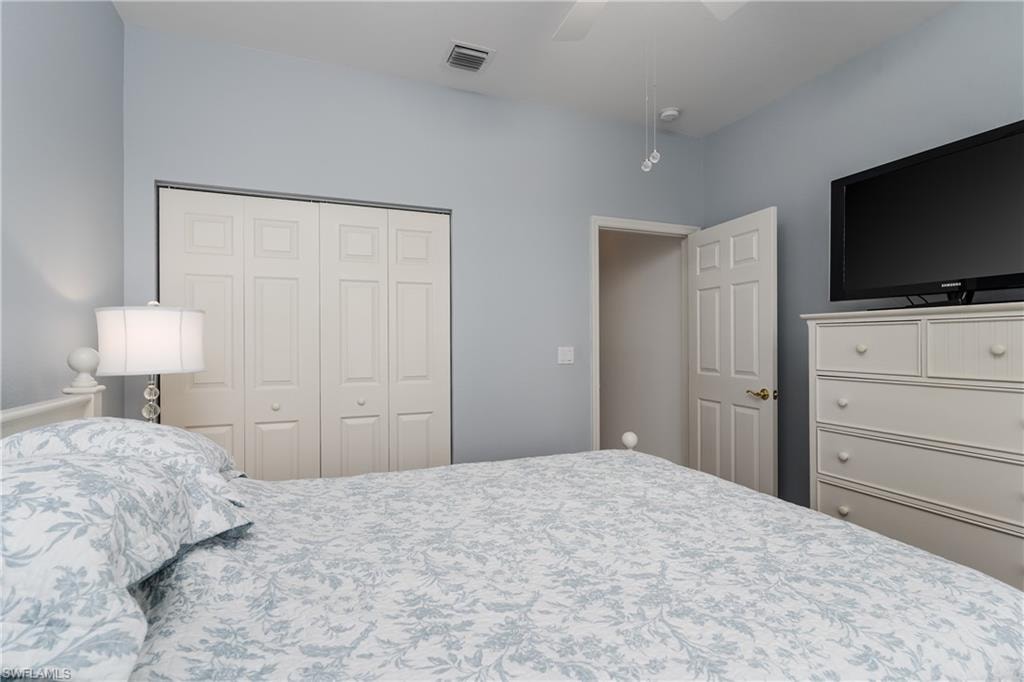 Vaulted ceiling with a flush-mount light fixture, painted interior door, and bi-fold closet doors