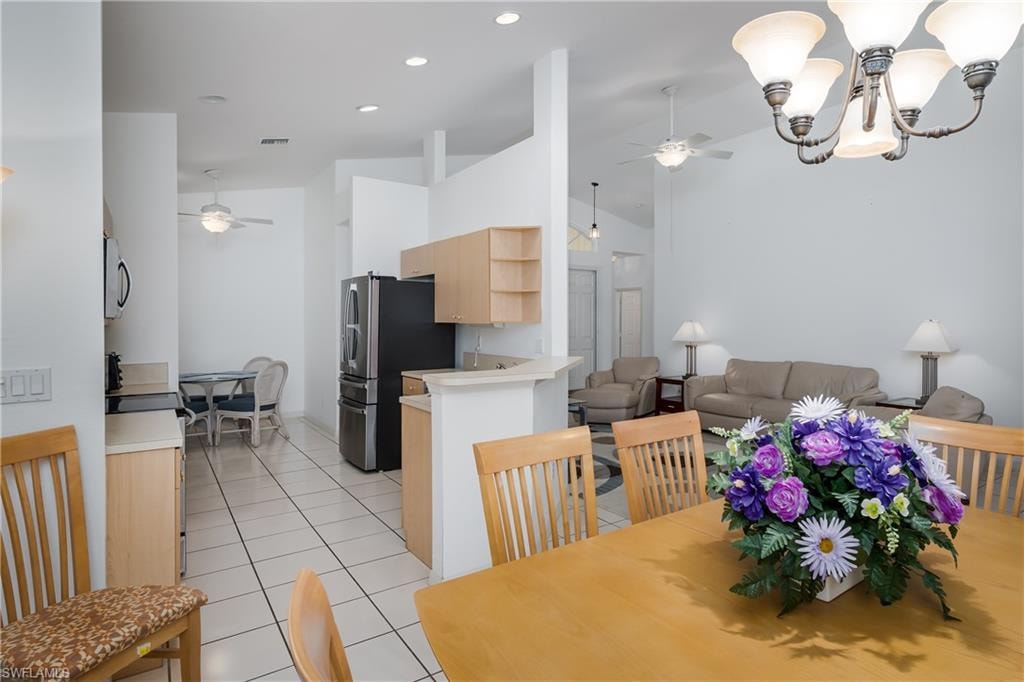 Tile flooring throughout, recessed lighting, and vaulted ceilings
