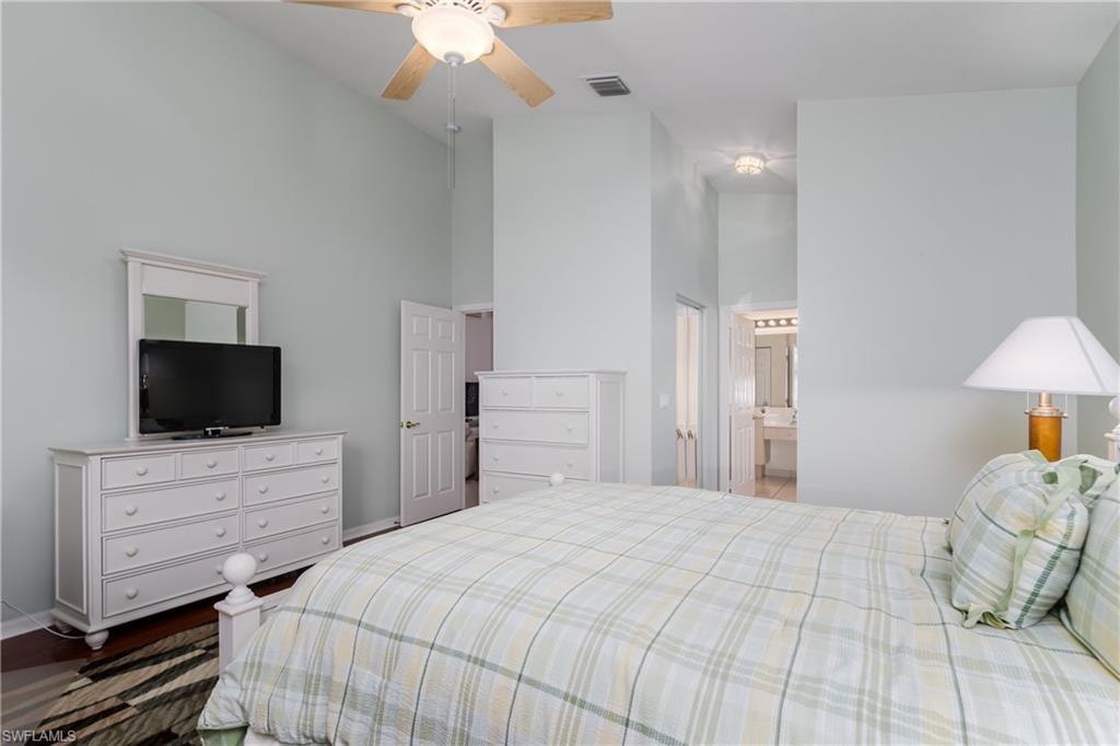 Vaulted ceilings, wood-finish flooring, and a ceiling fan with integrated lighting