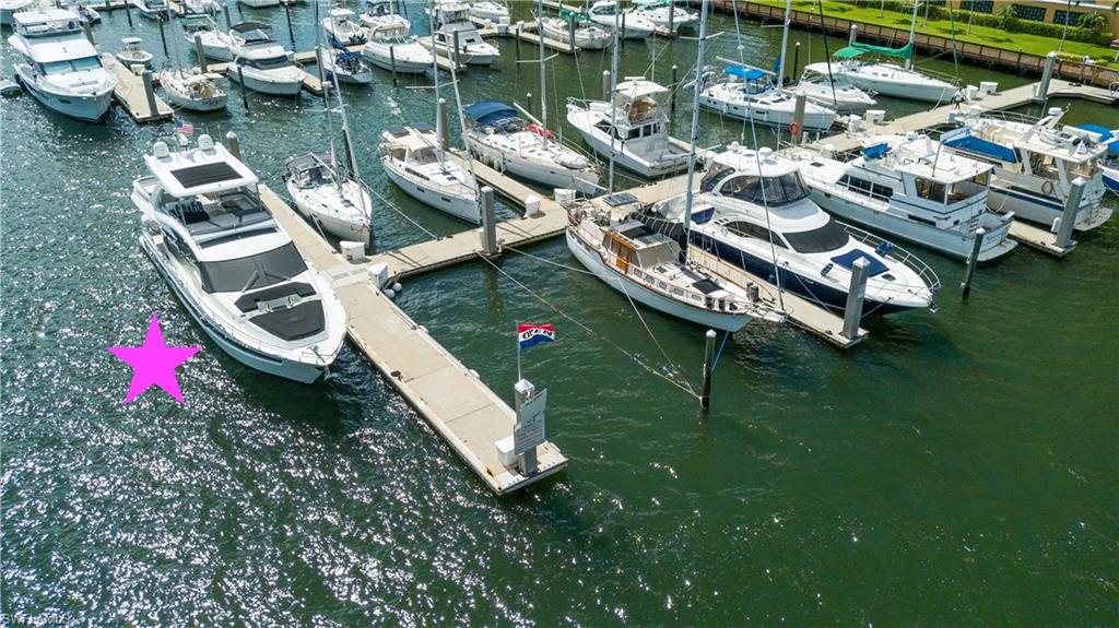 Dock featuring view of marina and a water view