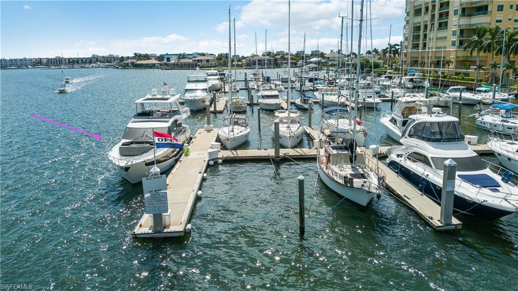 Dock area featuring a water view and view of marina
