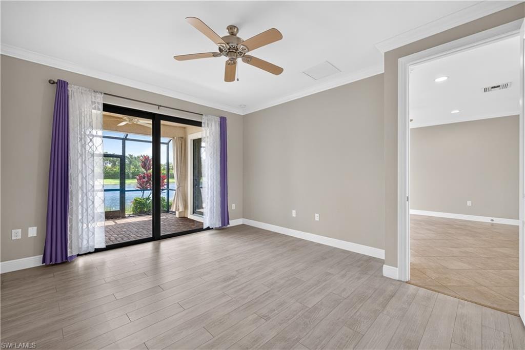 Sliding glass doors open to a screened lanai with tranquil water views