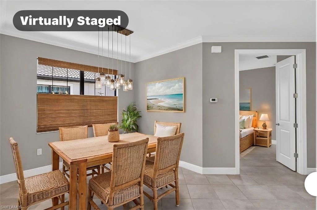 Dining area featuring tile flooring, a window with wood-finish blinds, and a multi-light pendant fixture