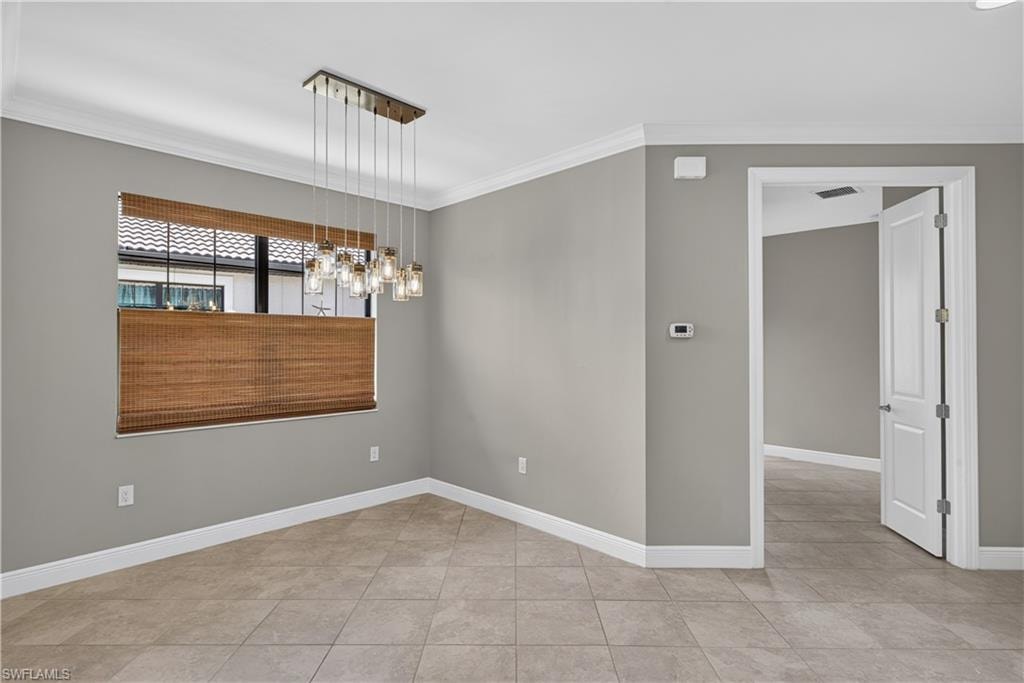 Dining area featuring tile flooring, a window with wood-finish blinds, and a multi-light pendant fixture