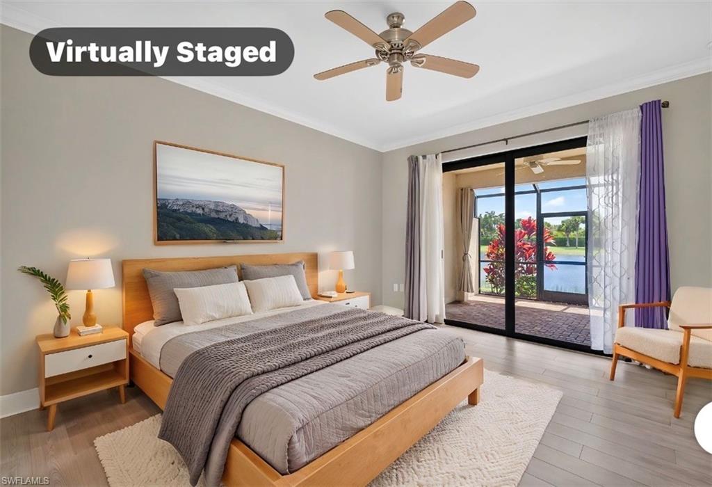 Spacious bedroom with  glass doors opening to a screened lanai and water views.
