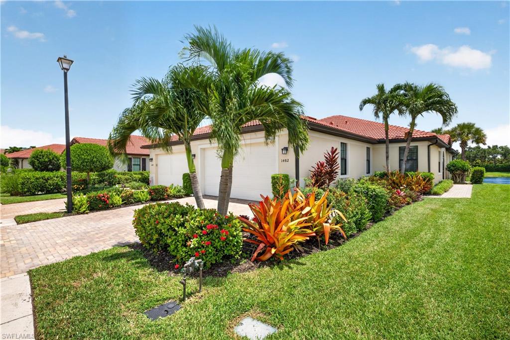 Beautiful landscaped yard, sidewalks and a lake behind the home