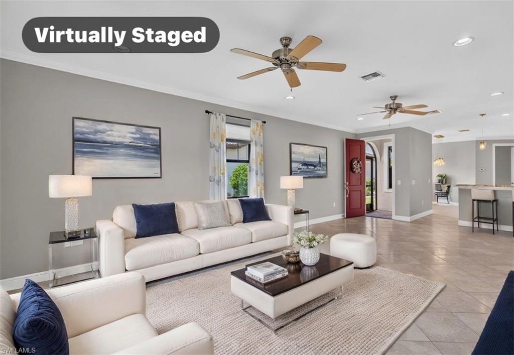 Spacious living area featuring gray walls, ceiling fans, recessed lighting, and tile flooring