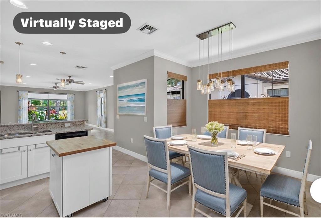 Dining area featuring a modern linear chandelier, tile flooring, and multiple windows with woven blinds that bring in a lot of natural light.